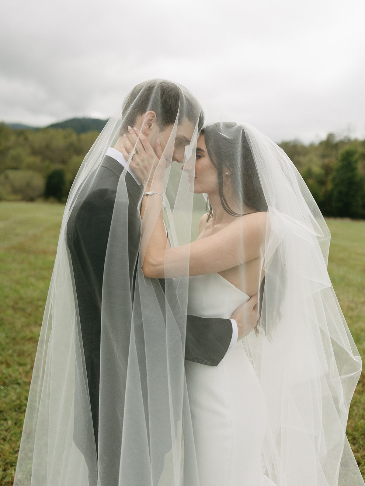 bride and groom photos under veil